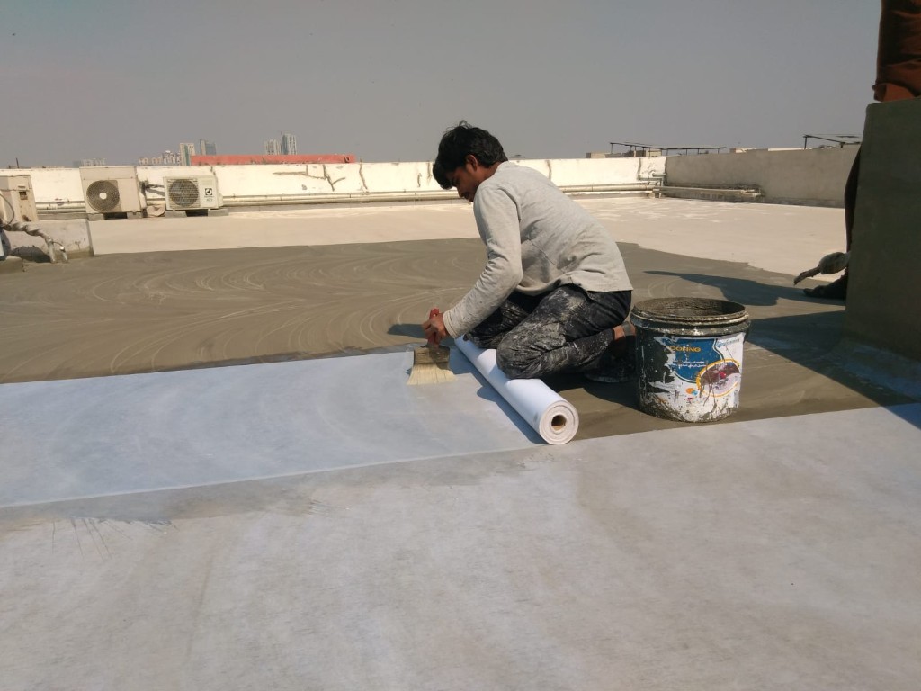 Flat rooftop with solar panels and reflective white heat-proof coating